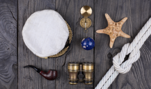 Nautical themed items including a compass, telescope, and a map, symbolizing navigation and leadership in project management consulting.