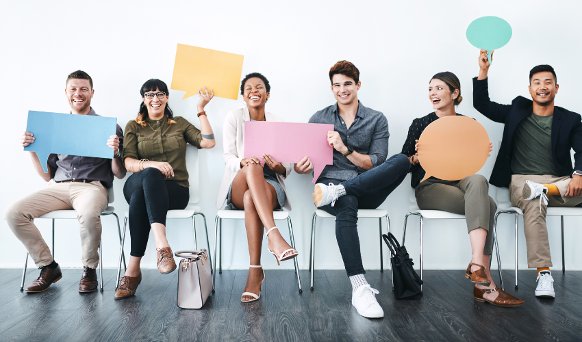 Six smiling business people holding speech bubbles