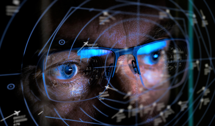 An air traffic controller's focused gaze superimposed on radar screens, denoting THE ROLE OF THE PROJECT MANAGER IN STEERING PROJECT TYPES TO SUCCESS.