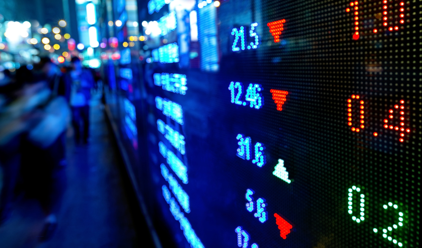 Stock market data display in a busy city environment representing the concept of external risks in project management.