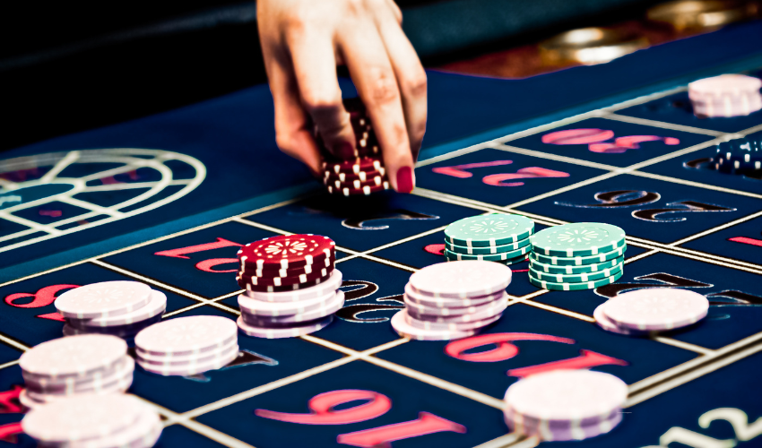 Casino roulette table with betting chips representing the concept of Monte Carlo simulation in project risk management.