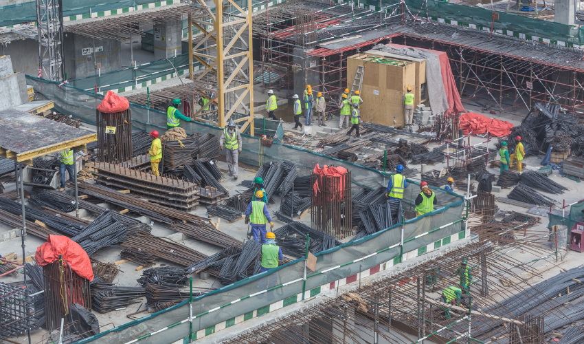 A team of construction workers building a bridge, representing collaboration in change management.