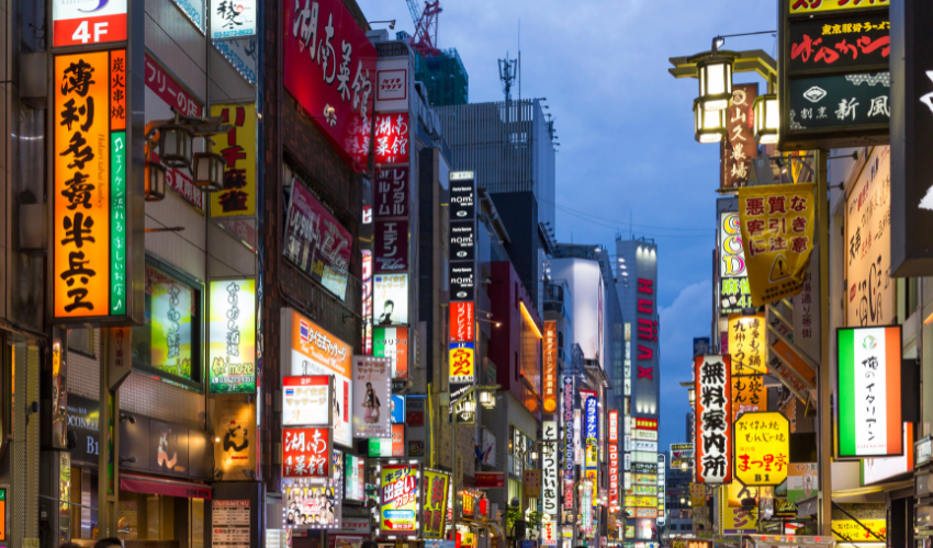 Busy street with lots of shop signs in Tokyo representing the various key change readiness factors in Prosci Change Management.